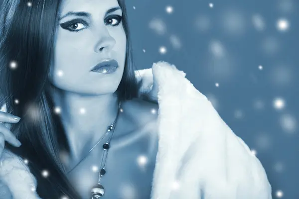Snow queen fashion winter portrait of a beautiful girl in fur