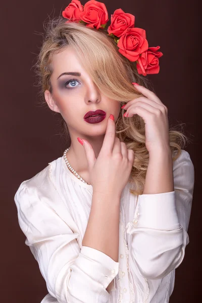 Sexy girl with flowers in head on brown background — Stock Photo, Image