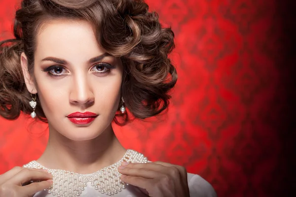 Fashion woman in red vintage room — Stock Photo, Image