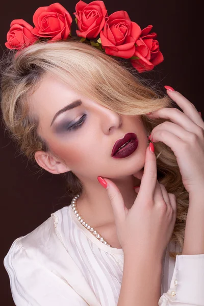 Sensual woman with flowers in head on brown background — Stock Photo, Image