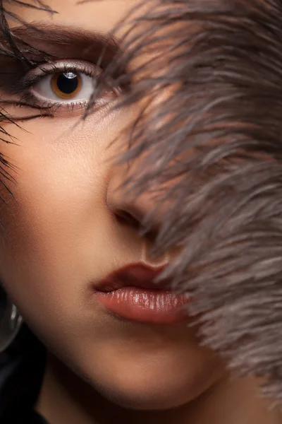 Portriat of woman with a feather at her eye — Stock Photo, Image