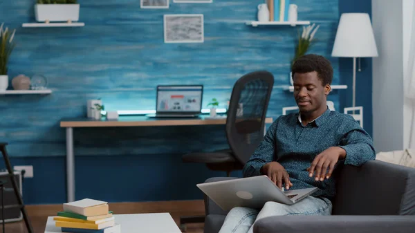 African american man browsing using laptop computer, searching social media — Stock Photo, Image