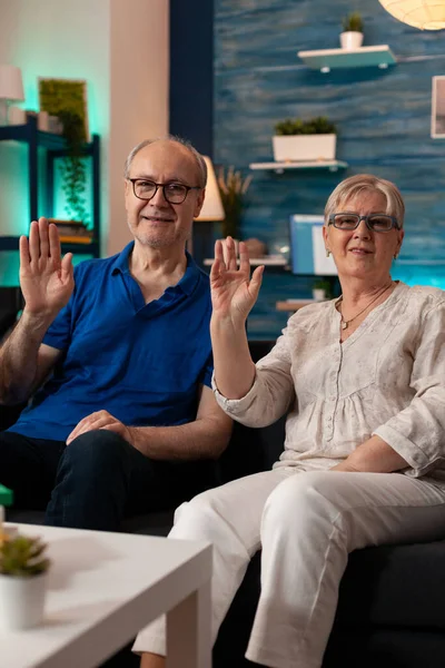 POV of retired couple waving hands on video call conference — Stock Photo, Image