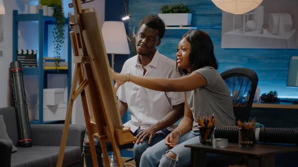 Young artists of african american ethnicity drawing on canvas — Stock Photo, Image
