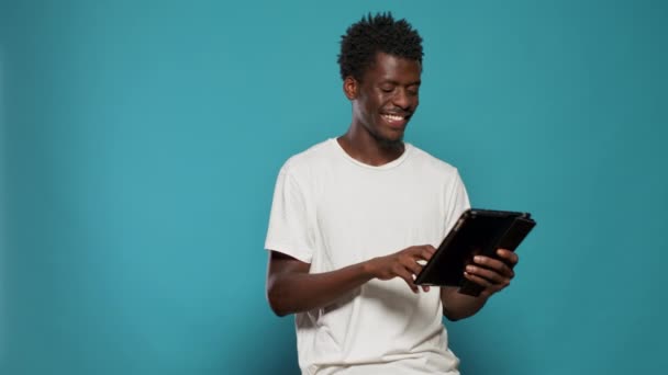 Afroamerikansk man med digital surfplatta och leende — Stockvideo
