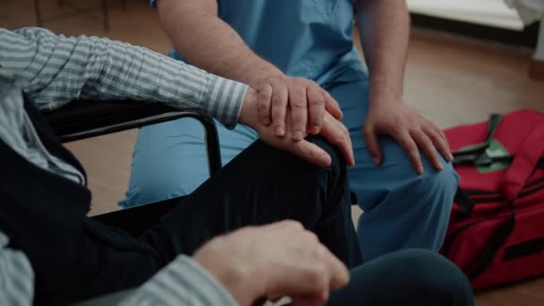 Närbild av händerna på sjuksköterska och äldre patient vid läkarbesök — Stockvideo