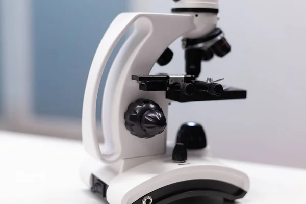 Close up of microscope with magnifying glass — Stock Photo, Image