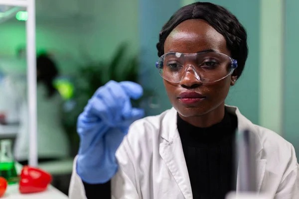 Close-up van de Afrikaans-Amerikaanse biochemicus vrouw met groen blad monster — Stockfoto