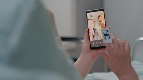 Close up of retired patient holding smartphone for video call — Stock Video