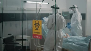 Klinikteki tecrit bölgesinde koruma takan sağlık görevlileri
