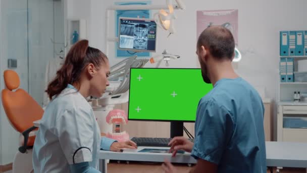 Enfermeira e dentista examinando layout dentes usando tela verde — Vídeo de Stock