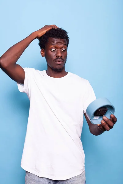 Portrait of man with wall clock holding hand on head — Stock Photo, Image