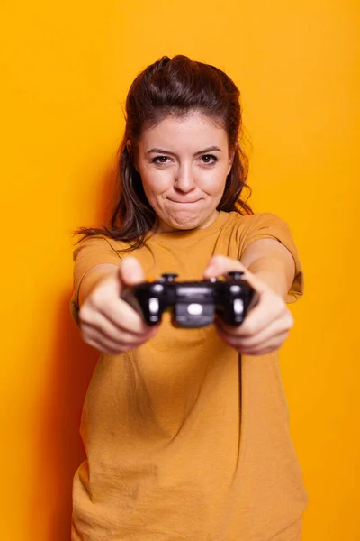Portrait of adult with controller on console in front of camera — Stock Photo, Image