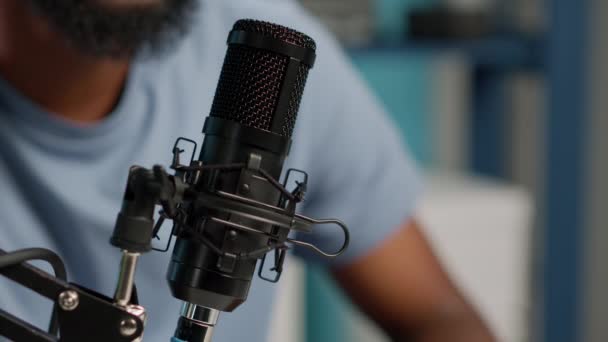 Gros plan du vlogger noir à l'aide du microphone sur podcast — Video