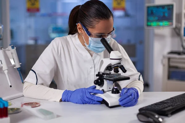 Specialist researcher analyzing genetic sample using medical microscope — Stock Photo, Image