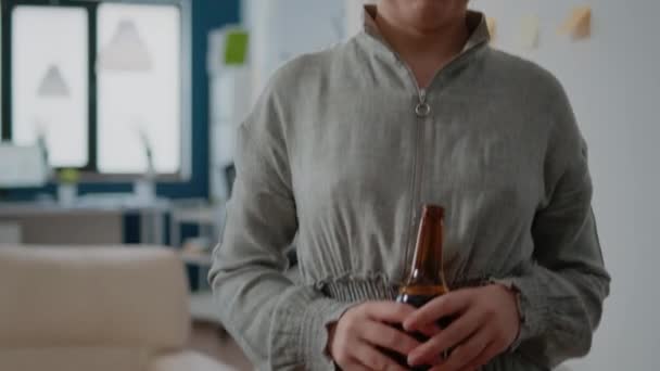 Portrait of woman with bottle of beer in hand for drinks after work — Stock Video