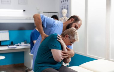 Osteopatik asistanın omuz ve omuz kemiklerini kırması