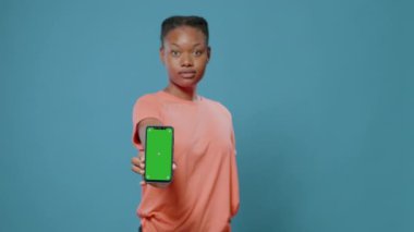 Yeşil ekranlı akıllı telefonu gösteren kadının yakın plan görüntüsü