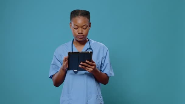 Portrét zdravotní sestry pracující na digitálním tabletu s dotykovým displejem — Stock video