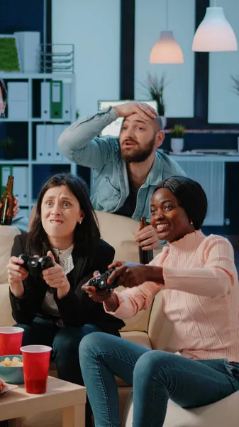 Colleagues losing at video games on console after work — Stock Photo, Image