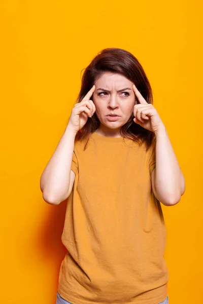 Umsichtige Frau denkt mit Fingern an Schläfen über Idee nach — Stockfoto