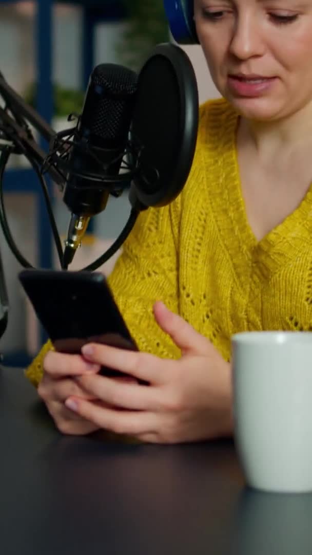 Vertical video: Video blogger reading questions from fans using smartphone