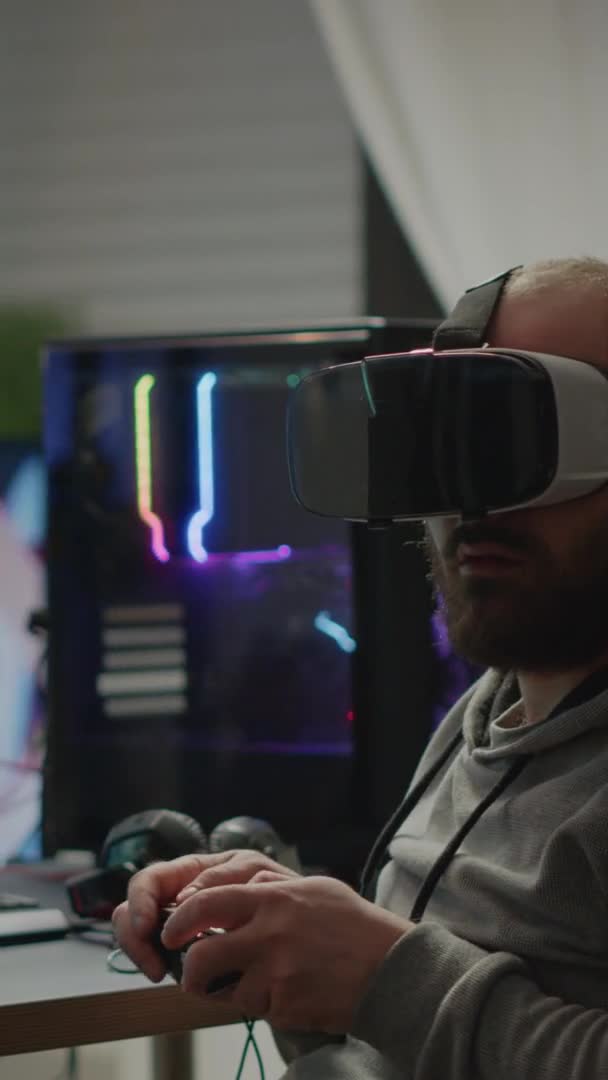 Vídeo vertical: Jugador cibernético profesional que gana jugando videojuegos con auriculares vr — Vídeos de Stock