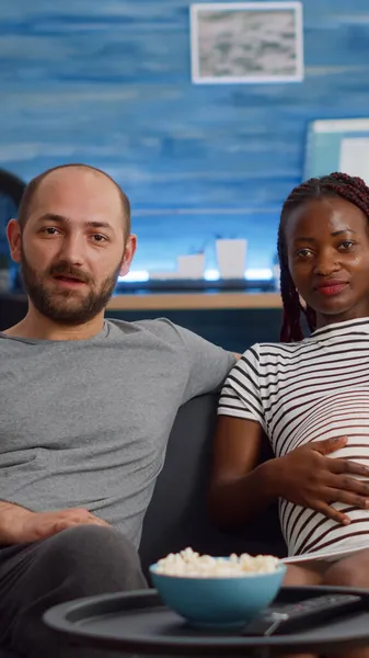 Pregnant interracial couple using video call conference — Stock Photo, Image