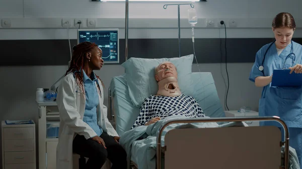 Multi ethnic medical staff checking on patient healthcare — Stock Photo, Image