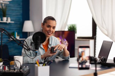 Sosyal medya sunucusu fare fare ürünü incelemesi yapıyor.