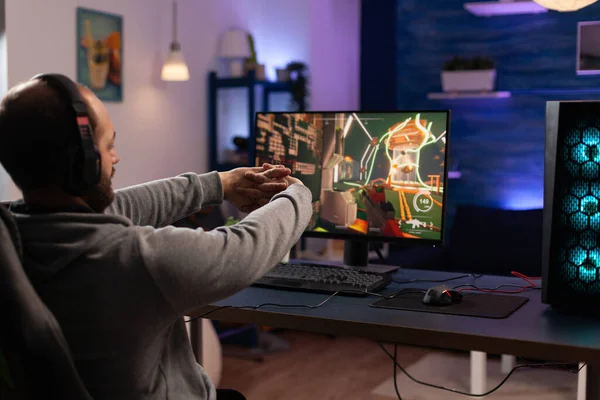 Man gamer teaching his girlfriend playing space shooter video game on RGB  powerful personal computer. Pro cyber woman with headset performing video  games streaming from home during online tournament Stock Photo 