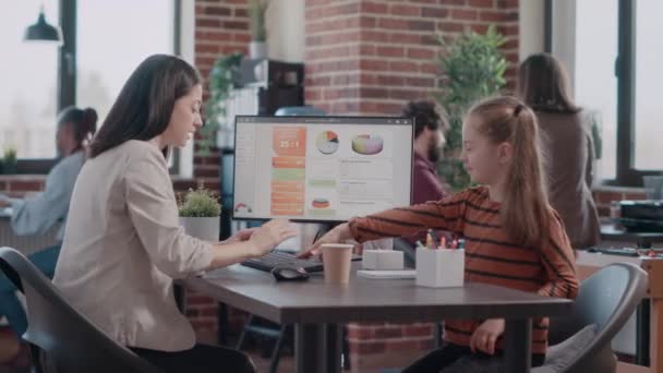 Little girl distracting multi ethnic team of business people while mother using computer — Stock Video