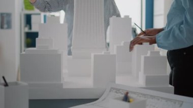 Bina modeli ve planlı kadınları masaya yakın tutun.