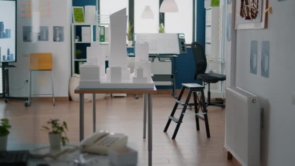 Leerer architektonischer Raum mit Baumodell und Maquette zur Erstellung eines Immobilienplans auf dem Schreibtisch — Stockvideo