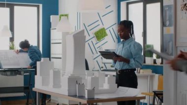 Afrika kökenli Amerikalı mimar dijital tabletle plan ve model oluşturmak için çalışıyor.