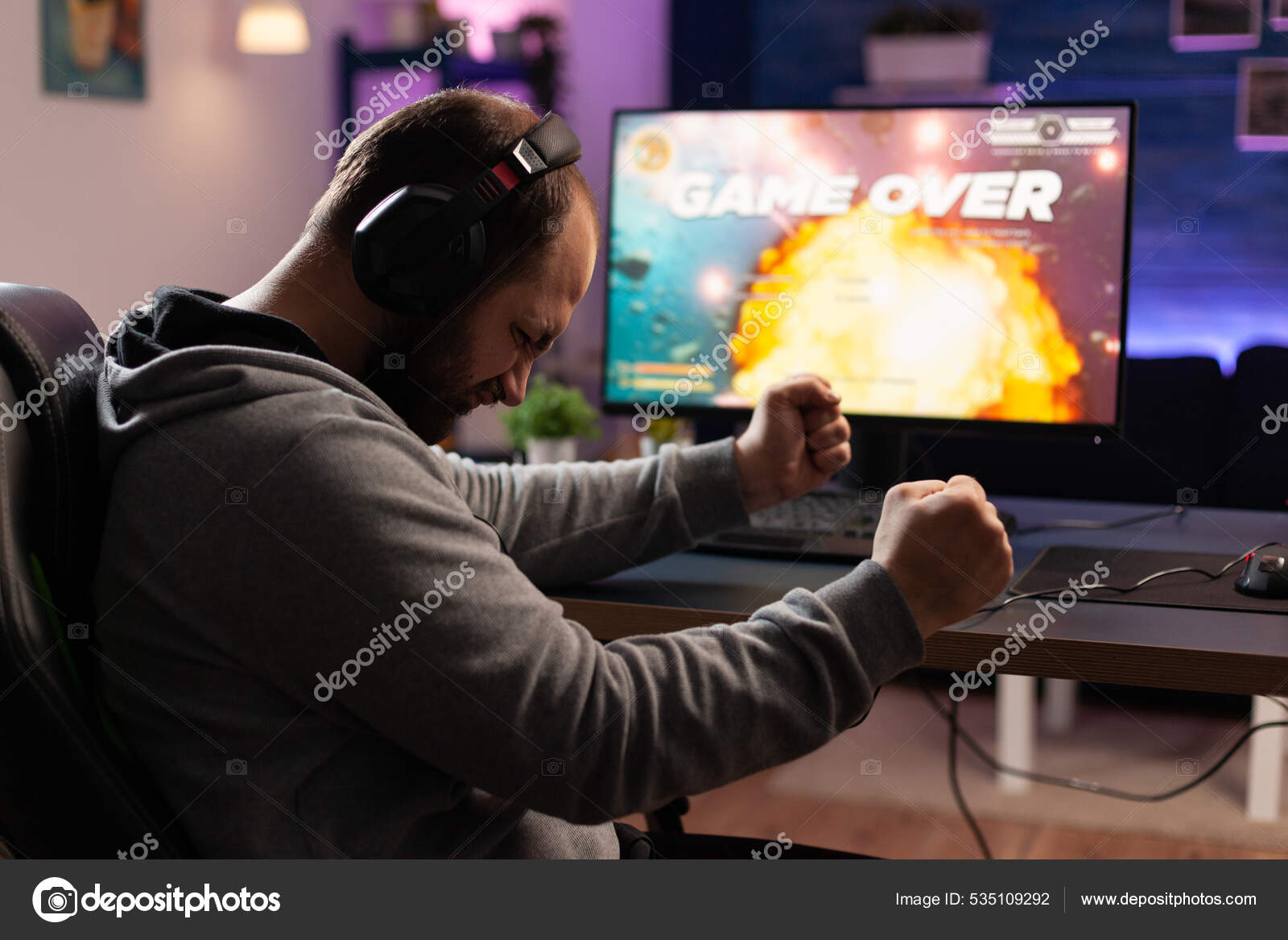 Person playing video games with controller on computer Stock Photo