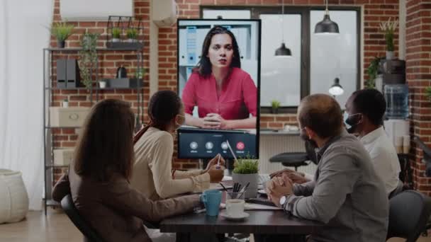 Colleagues meeting with woman on video call conference — Stock Video