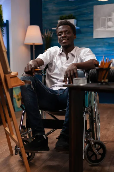 Retrato del hombre artista en silla de ruedas sonriendo a la cámara —  Fotos de Stock