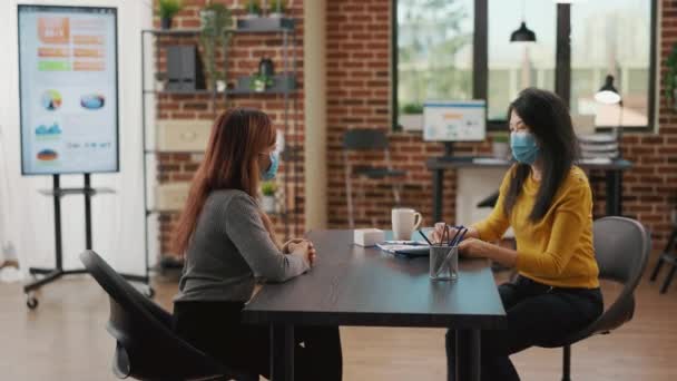 Asian woman signing hiring contract at job interview with business employee — Stockvideo