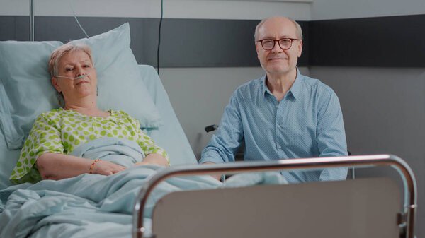 Portrait of senior people sitting in hospital ward