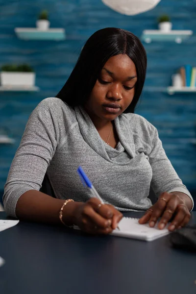 Young person using pen to write on notebook file — Stock Photo, Image