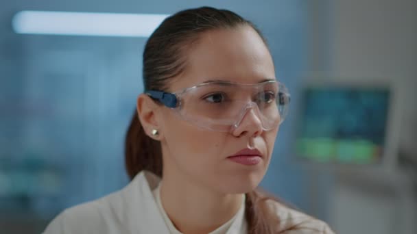 Laboratuvarda koruyucu gözlüklü kadın bilim adamı. — Stok video