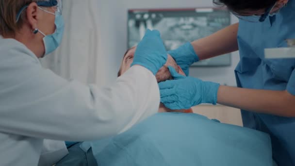 Pacjent z problemami z próchnicą otrzymujący konsultacje od zespołu stomatologicznego — Wideo stockowe