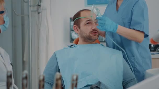 Patient with oxygen mask receiving anesthesic in dentistry cabinet — Stock Video