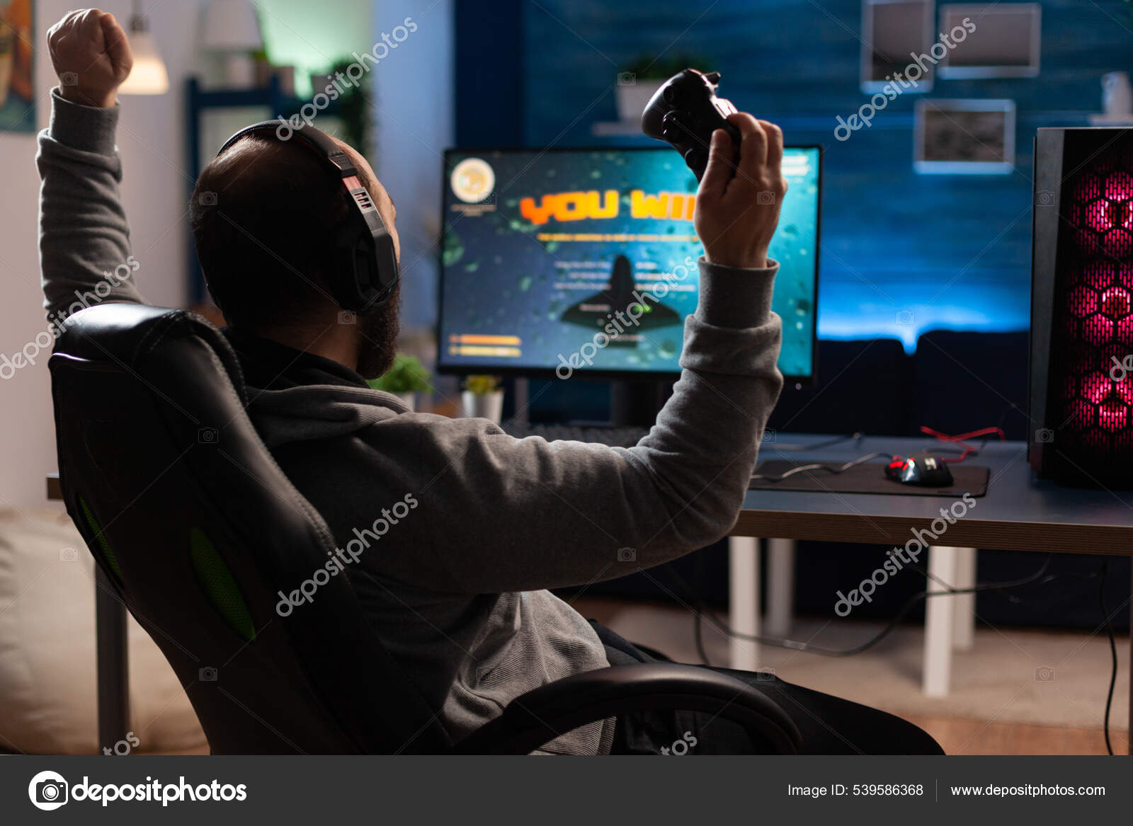 Free Photo  Player winning video games with controller and headset in  front of monitor. man using joystick and headphones, playing online games  on computer. person celebrating game win for leisure.