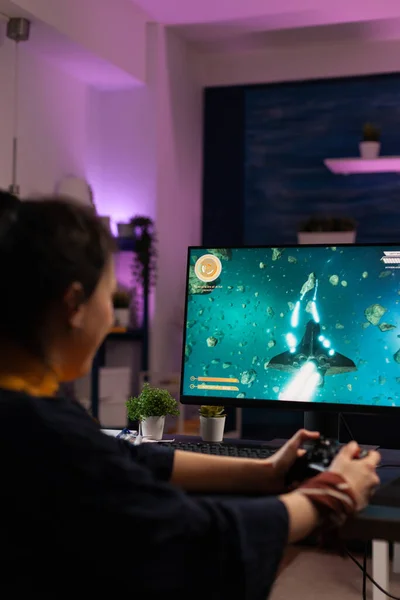 Gamer playing video games with joystick on monitor — Stock Fotó
