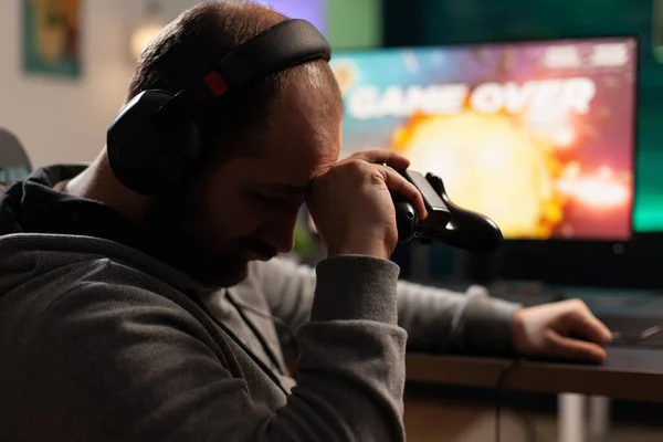 Sad gamer losing video games after playing with controller — Stock Fotó