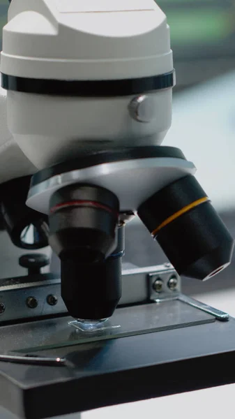 Close up of glass lens microscope on laboratory desk — Stock Photo, Image