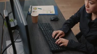 Focus on programer hands typing code on keyboard while looking at computer screen