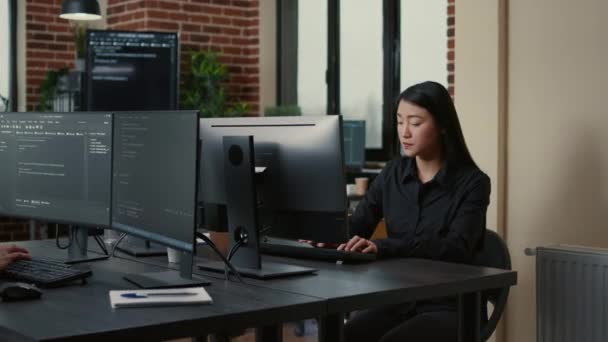 Portrait of asian programer focused on writing code sitting at desk — Stockvideo